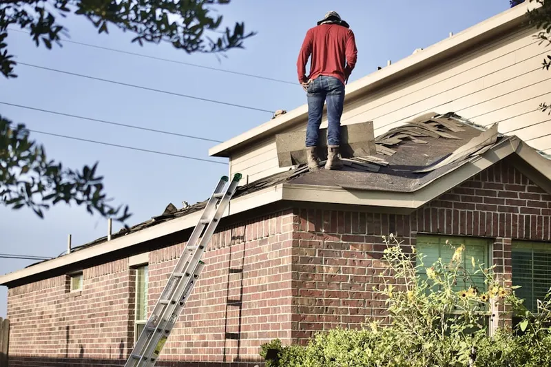 Professional roofer working on a residential roof in Elkins Park